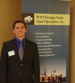 A man standing in front of a sign.