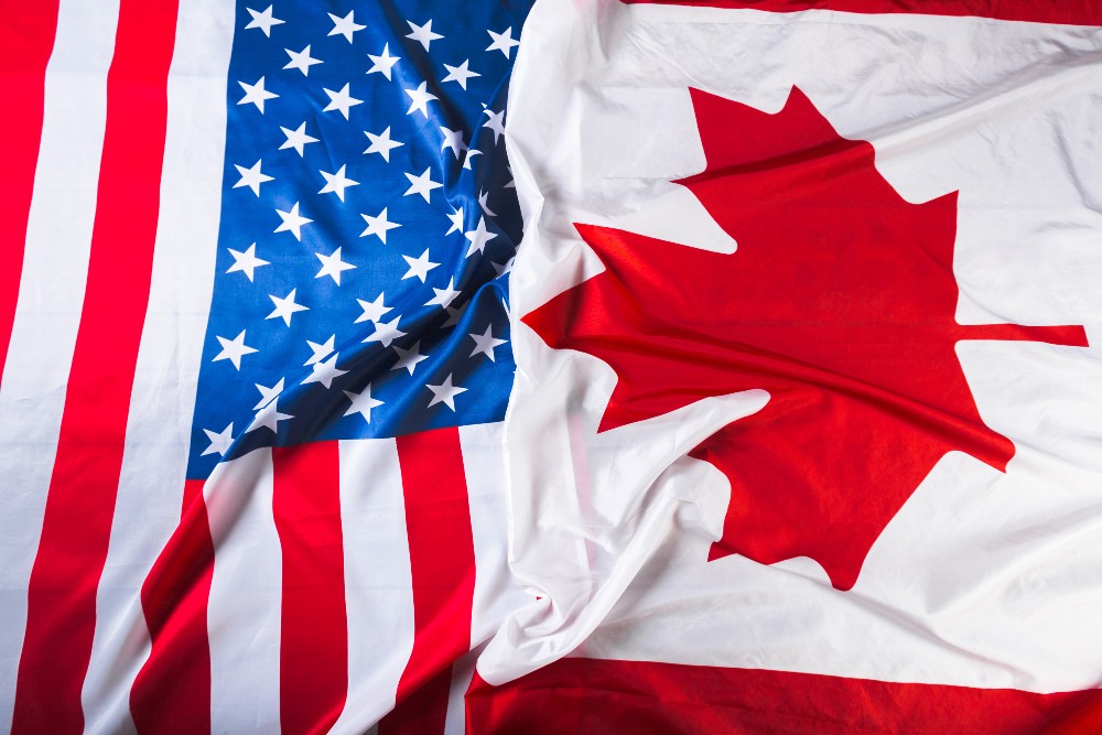 A close up of the american flag and canadian flag