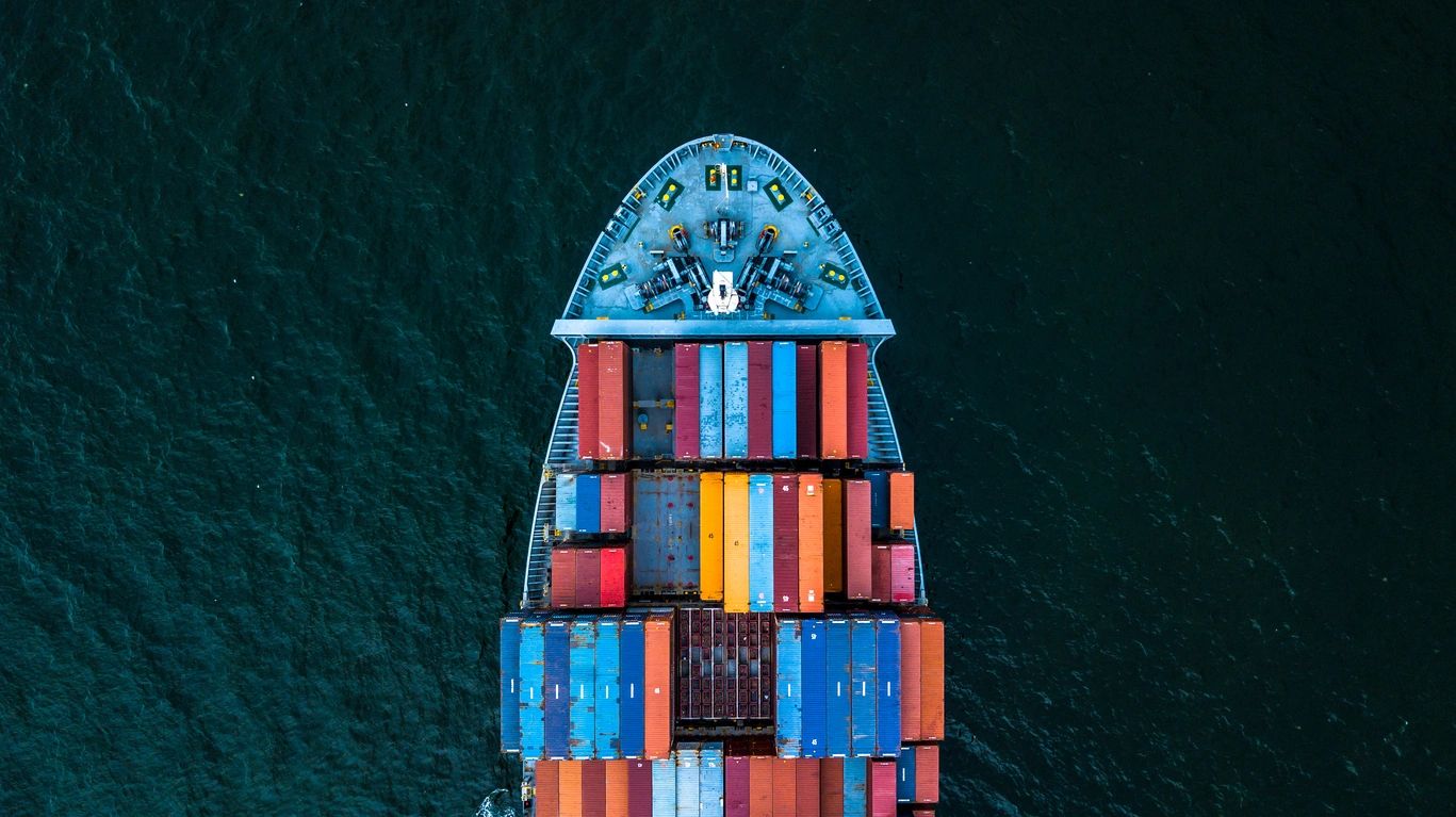 A ship with many containers stacked on top of it.